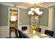Formal dining room with view of kitchen and chandelier at 7713 Stonehenge Farm Ln, Raleigh, NC 27613