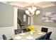 Formal dining room features chandelier and staircase view at 7713 Stonehenge Farm Ln, Raleigh, NC 27613