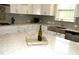 Kitchen island with wine glasses and bottle on a rustic tray at 7713 Stonehenge Farm Ln, Raleigh, NC 27613