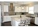 Modern kitchen with white cabinets, a farmhouse sink, and an island at 7713 Stonehenge Farm Ln, Raleigh, NC 27613