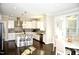 Spacious kitchen with white cabinets, stainless steel appliances, and an island at 7713 Stonehenge Farm Ln, Raleigh, NC 27613