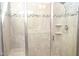 Large tiled shower with a built-in seat and glass enclosure at 7713 Stonehenge Farm Ln, Raleigh, NC 27613