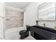 Modern bathroom with black vanity, shower and toilet at 8309 Stryker Ct, Raleigh, NC 27615