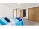 Well-lit bedroom with light blue bedding and double doors to closet at 8309 Stryker Ct, Raleigh, NC 27615