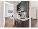 Wet bar with wine rack and quartz countertop at 8309 Stryker Ct, Raleigh, NC 27615