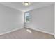 Simple bedroom with grey carpet and a window at 8951 Kennebec Crossing Dr # 51, Angier, NC 27501
