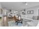 Open living room features hardwood floors, a cozy sectional sofa, and large windows at 8951 Kennebec Crossing Dr # 51, Angier, NC 27501