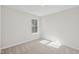 Cozy bedroom with neutral carpet, a window and fresh paint at 907 Montague Ave, Durham, NC 27703