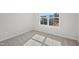 Bright bedroom featuring neutral carpet, a window view and fresh paint at 907 Montague Ave, Durham, NC 27703