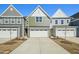 Charming townhome showcasing a well-manicured lawn and an attached one car garage at 907 Montague Ave, Durham, NC 27703