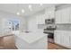 Modern kitchen featuring a large island, stainless steel appliances, and ample cabinet space at 907 Montague Ave, Durham, NC 27703