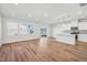 Bright living area with hardwood floors, white kitchen, island and slider door to fenced yard at 907 Montague Ave, Durham, NC 27703