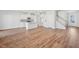Open-concept living space with hardwood floors, white walls, and staircase with natural light at 907 Montague Ave, Durham, NC 27703