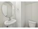 Compact half bathroom featuring a pedestal sink and toilet at 907 Montague Ave, Durham, NC 27703