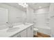 Bright bathroom features double sinks, white cabinets, and a shower-tub combo at 911 Montague Ave, Durham, NC 27703