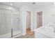 Well-lit primary bathroom showcases walk-in shower and access to toilet and walk-in closet at 911 Montague Ave, Durham, NC 27703