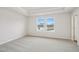 Serene bedroom with soft carpet, a tray ceiling, and lots of natural light from large windows at 911 Montague Ave, Durham, NC 27703
