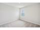 Cozy bedroom with neutral carpet, ample natural light, and a clean, minimalist design at 911 Montague Ave, Durham, NC 27703