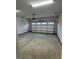 An empty two car garage with concrete floors and white walls is ready for your vehicles and storage needs at 911 Montague Ave, Durham, NC 27703