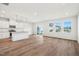 Bright living area flows into a stylish kitchen, showcasing hardwood floors and natural light at 911 Montague Ave, Durham, NC 27703