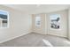 Spacious bedroom with plush carpeting and multiple windows offering ample natural light at 913 Montague Ave, Durham, NC 27703