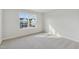 Sunlit empty bedroom featuring neutral carpet and a large window with neighborhood views at 913 Montague Ave, Durham, NC 27703
