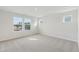 Empty bedroom featuring neutral carpet and three windows offering neighborhood views at 913 Montague Ave, Durham, NC 27703