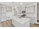 Modern kitchen featuring an island, gray cabinets, stainless steel appliances, and stylish pendant lighting at 913 Montague Ave, Durham, NC 27703