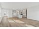 Open-concept living space with light wood floors and stylish gray kitchen at 913 Montague Ave, Durham, NC 27703