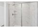 A close up of shower featuring sleek tile, showerhead, and built in shelf at 913 Montague Ave, Durham, NC 27703