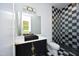 Bathroom with black vanity and checkered shower at 914 Ardmore Dr, Durham, NC 27713