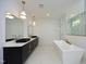 Luxurious bathroom with double vanity, soaking tub, and marble tile at 914 Ardmore Dr, Durham, NC 27713