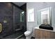 Modern bathroom with dark tile and floating vanity at 914 Ardmore Dr, Durham, NC 27713