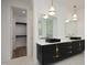 Double vanity bathroom with black cabinets and gold fixtures at 914 Ardmore Dr, Durham, NC 27713