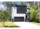 Two-story modern home with white and dark gray siding, stone accents, and a two-car garage at 914 Ardmore Dr, Durham, NC 27713