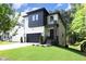 Modern two-story house with white and black exterior, stone accents, and a landscaped yard at 914 Ardmore Dr, Durham, NC 27713