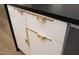 Modern kitchen cabinets with gold handles and white doors at 914 Ardmore Dr, Durham, NC 27713