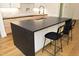Kitchen island with black countertop and two black barstools at 914 Ardmore Dr, Durham, NC 27713