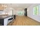Open concept kitchen and living area with hardwood floors and a modern fireplace at 914 Ardmore Dr, Durham, NC 27713