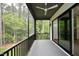 Screened porch with ceiling fan and wooded views at 914 Ardmore Dr, Durham, NC 27713