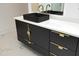 Modern black vanity with white countertop and gold hardware at 914 Ardmore Dr, Durham, NC 27713