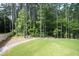 Landscaped backyard with a retaining wall and trees at 916 Ardmore Dr, Durham, NC 27713