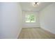 Bright bedroom with hardwood floors and large windows at 916 Ardmore Dr, Durham, NC 27713