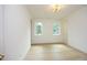 Well-lit bedroom featuring hardwood floors and two windows at 916 Ardmore Dr, Durham, NC 27713