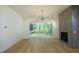 Bright living room features hardwood floors, fireplace, and sliding glass doors leading to a deck at 916 Ardmore Dr, Durham, NC 27713