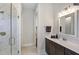 Bathroom features a walk-in shower, vanity with quartz countertop, and a large mirror at 1 Kelsey Ct, Hillsborough, NC 27278