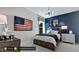 bedroom with navy walls, basketball hoop, and US flag art at 1 Kelsey Ct, Hillsborough, NC 27278
