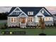Two-story home with gray and white exterior and stone accents at 1 Kelsey Ct, Hillsborough, NC 27278