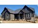 Dark gray siding, brick accents, and a welcoming front porch characterize this craftsman style home at 1 Kelsey Ct, Hillsborough, NC 27278
