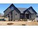 Craftsman style home with dark gray siding, brick accents, and a welcoming front porch at 1 Kelsey Ct, Hillsborough, NC 27278
